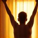 A person stretching after waking up, symbolizing vitality and energy